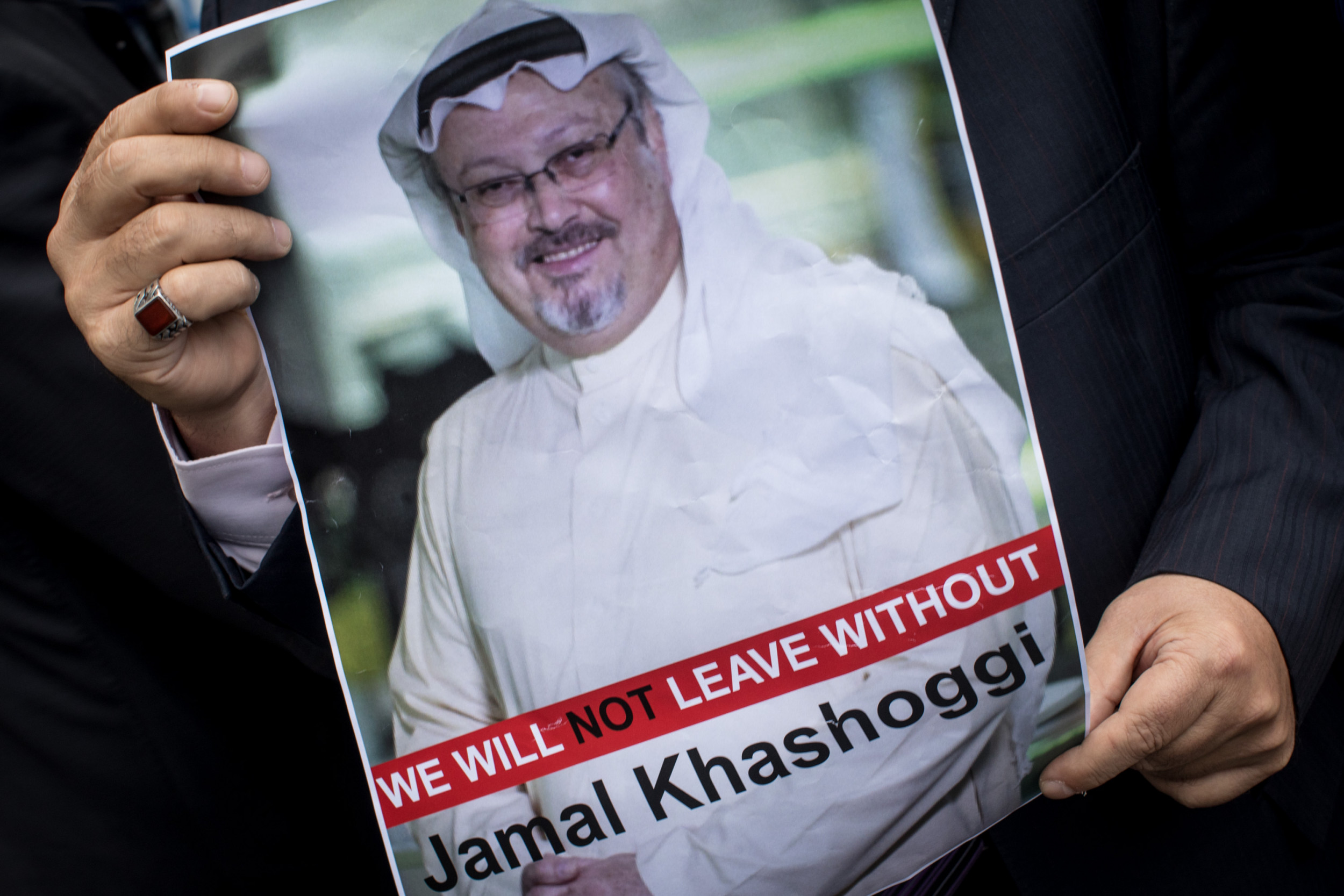 someone holding Jamal Khashoggi's picture